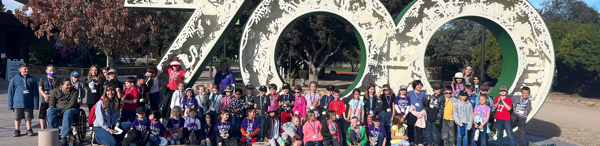 Students and staff in front of a large 700 structure