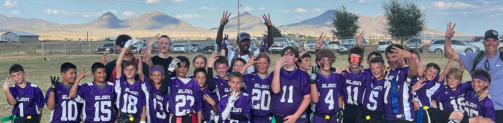 Sonoita football team posing together behind sign the reads congratulations football champions