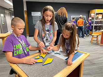 three students working on a puzzle
