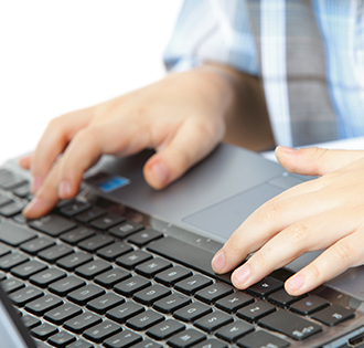 Young boy using laptop to connect to online resources