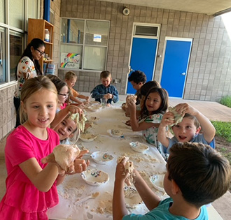 students and staff gathered around a table