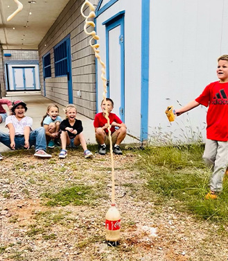 students playing with coke and mentos