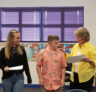 Two adults and student at a board meeting