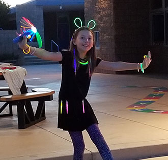 Female student wearing a bunch of glowsticks
