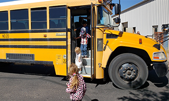 students getting out of a bus