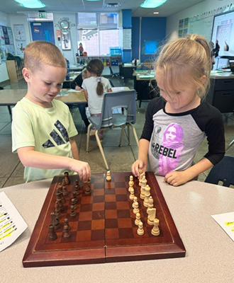 Two students playing musical chairs